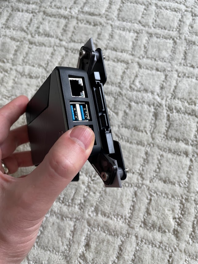 Final Raspberry Pi in a Coolermaster case with an SSD and VESA mounting plate.