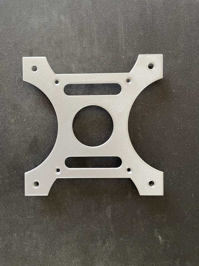 Flat bottom of the plate with countersunk holes.